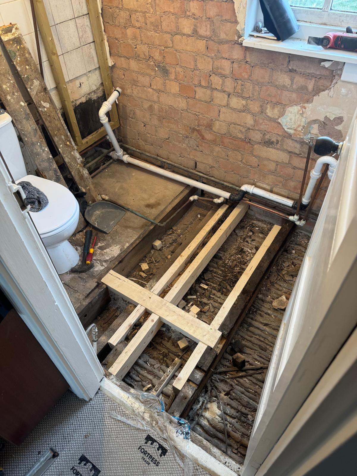 Bathroom floor drainage pipework installation in progress in Leicestershire