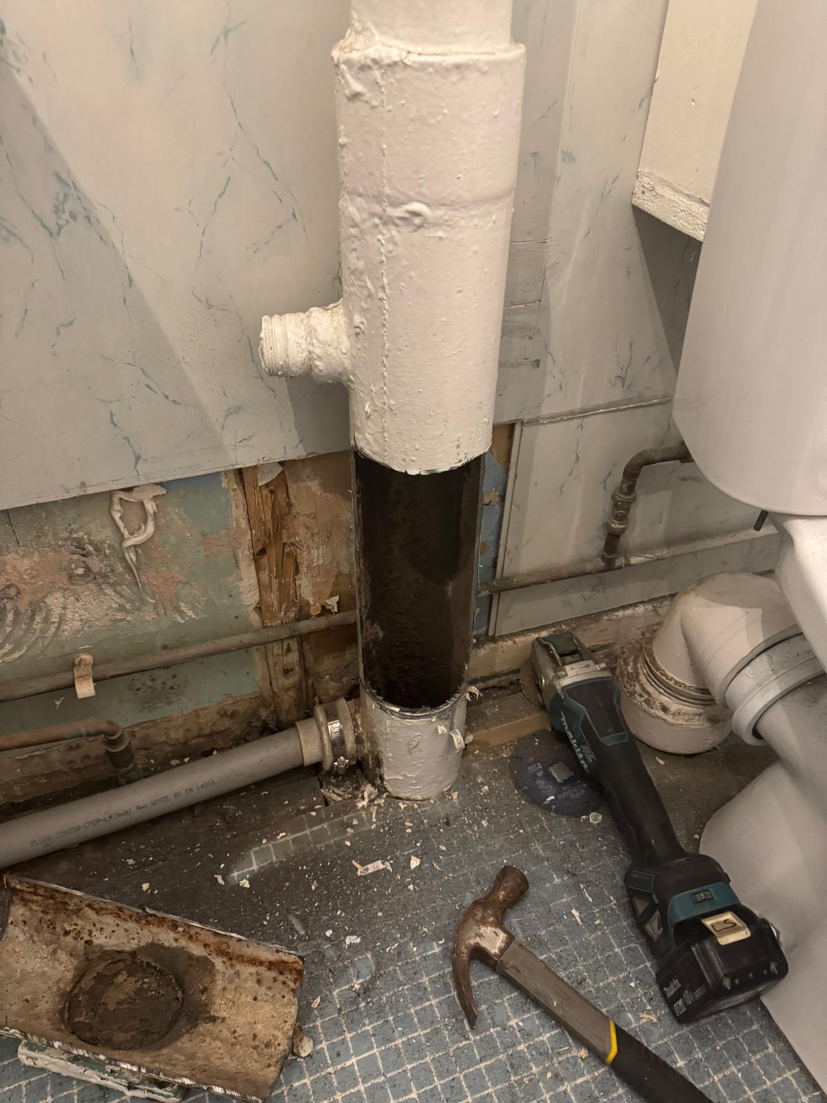 Cast iron soil pipe removal in progress by Reactive drainage engineers